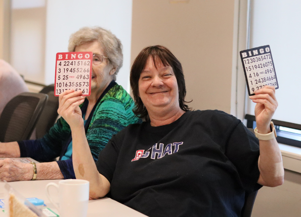 Two older adults reviewing paperwork together at a table