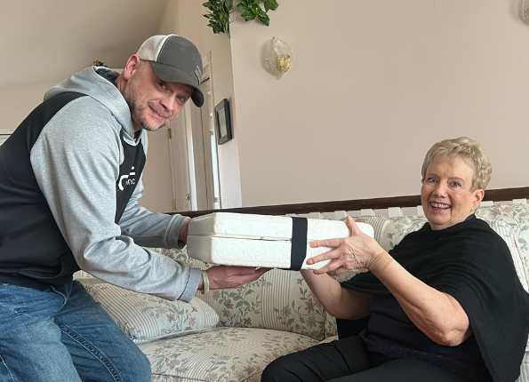 Two older adults reviewing paperwork together at a table