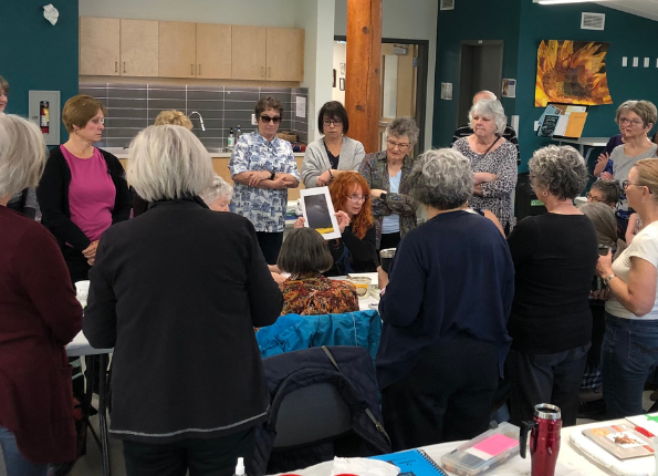 Older adults attending a presentation in a community room
